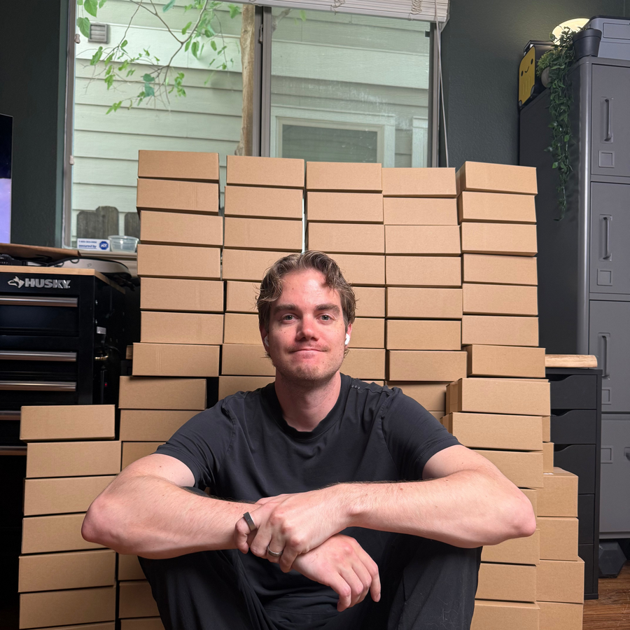 Luke in the JellyLab workshop with a shipment of finished watches and boxes