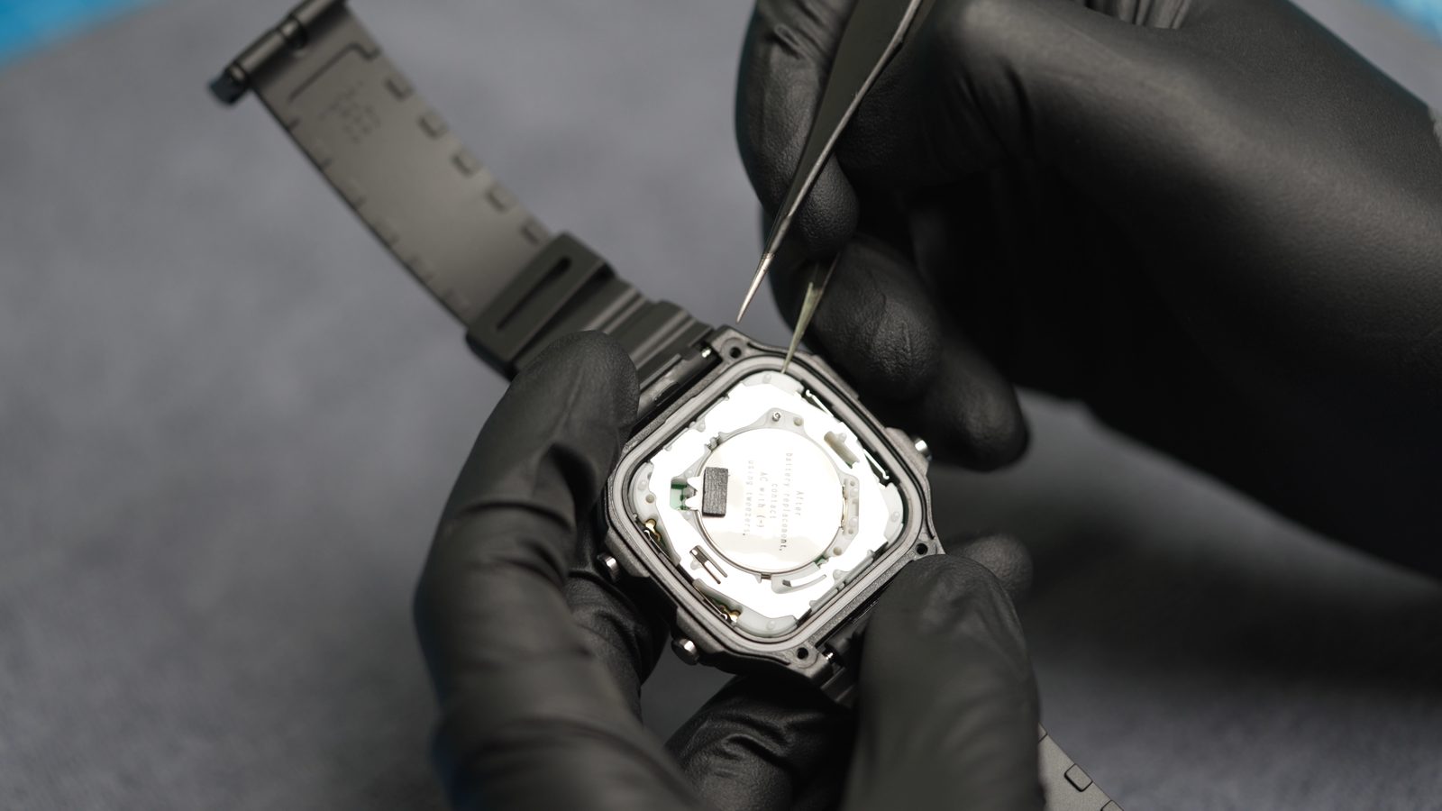 Prying the Casio AE-1200 time module out by a plastic-wrapped corner